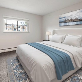 a bedroom with a bed and a tv